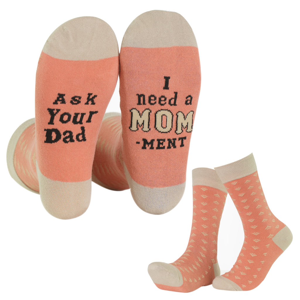 Pair of socks with text 'Ask Your Dad' and 'I need a MOM-ment' on a white background.